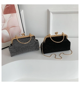 Detailed view of luxury rhinestone clutch bags in silver and black with gold handles