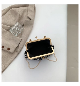 Close-up of retro rhinestone evening bag featuring gold metal clasp and chain strap