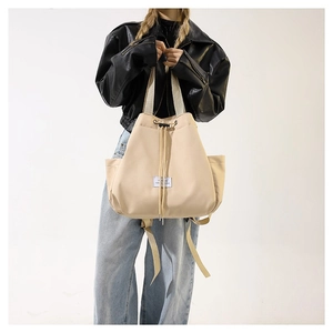 Chic beige nylon drawstring bucket bag with side pockets and wide webbing handles