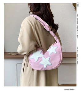 Detail view of pink crescent nylon shoulder bag with white plush star applique decorations