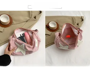 Detail view of the spacious pink nylon shoulder bag interior showing main compartment storage
