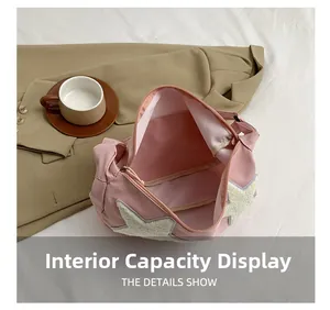 Detail showing internal storage space and star plush decor on pink nylon tote bag