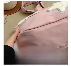 Detailed close-up of precise stitching and seam work on a pink nylon crossbody bag