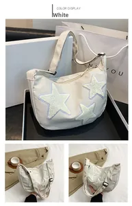 Detail of white nylon crescent bag with plush star patches and adjustable strap