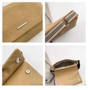 Détail du sac à bandoulière en cuir kaki avec sangle rayée et fermeture magnétique