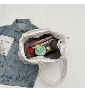 Interior view of large silver quilted tote bag showing spacious capacity for items