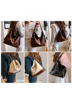 Detalle de bolso tote vintage de gran capacidad en colores negro, marrón y beige