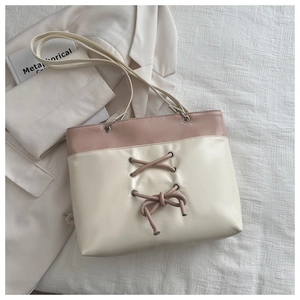 Detail of minimalist cream and pink tote bag with stylish drawstring bow decoration