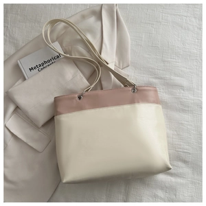 Detail of pink and beige patchwork leather tote bag with silver metal ring connectors