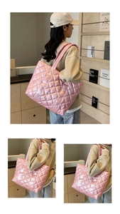 Detail of pink quilted rhombic shoulder bag with a glossy texture and wide strap