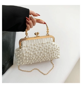 Détail du sac de soirée blanc perlé avec fermoir coeur, poignée dorée et gravures