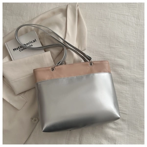 Detail view of the pink and silver leather tote bag with metallic sheen and slim straps