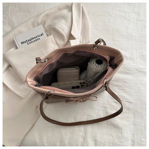 Top view of pink tote bag showing large capacity interior with daily items and bow detail