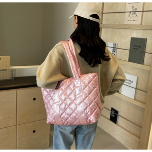 Close-up of pink quilted tote bag showing metallic texture and rhombic pattern detailing