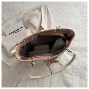 Macro detail of large cream tote bag interior showing spacious capacity and zipper closure