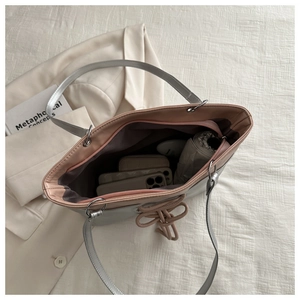Silver tote bag with pink interior showing large capacity for phone and cosmetics