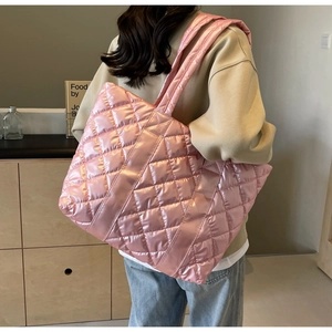 Detailed view of pink quilted tote bag with glossy finish and rhombus pattern
