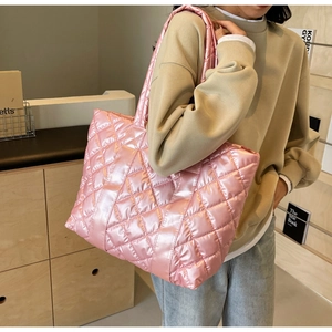 Detail of pink metallic quilted puffer tote bag with glossy nylon finish for women
