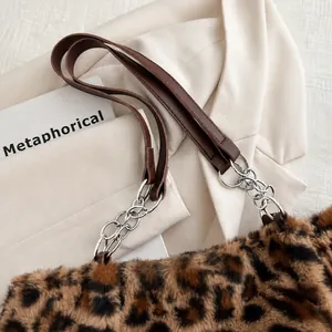 Close-up of leopard print faux fur texture with leather strap and silver chain detail