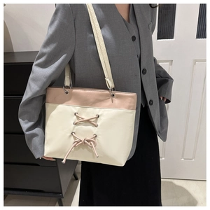Detailed view of the pink and beige tote bag featuring cross-lace corset design elements