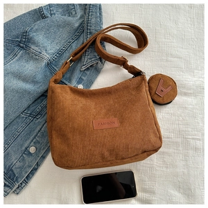 Detail view of brown corduroy hobo bag with a matching small round coin purse