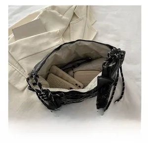 Interior view of black quilted tote bag showing spacious capacity for daily essentials
