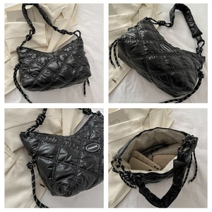 Detail view of black quilted nylon bag with rope handle and spacious interior storage