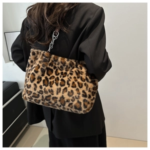 Elegante borsa tote in peluche leopardata con tracolla a catena indossata da modella