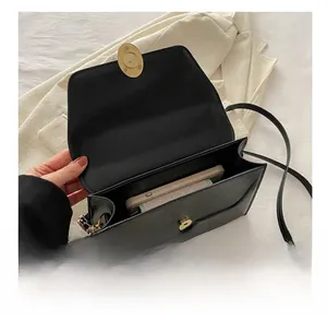 Interior view of black leather crossbody bag showing capacity for a smartphone