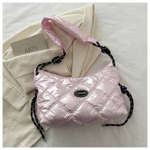 Detail of pink quilted puffer bag with glossy metallic finish and woven rope strap