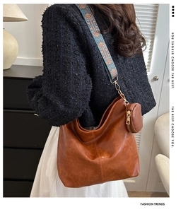 Brown leather crossbody bag with colorful jacquard ethnic strap and round coin purse detail