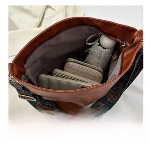 Spacious interior of brown PU leather tote bag with wide strap showing large capacity