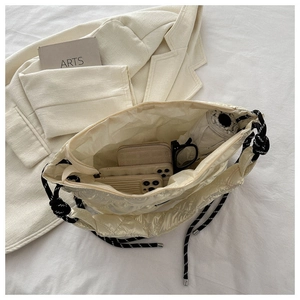 Top view of cream quilted tote bag showing large capacity for phone, wallet and umbrella