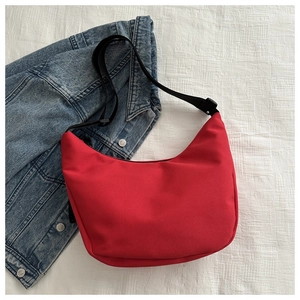 Detailed macro view of the bright red crescent hobo bag with durable nylon material