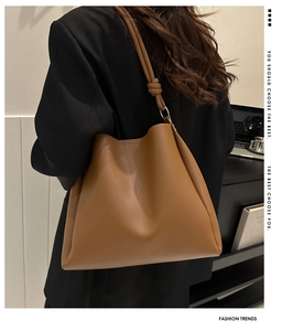 Detailed view of brown PU leather shoulder bag with knotted strap and metal ring