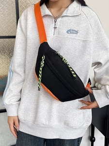 Black and orange crossbody chest bag in durable nylon with woven zip details for street style