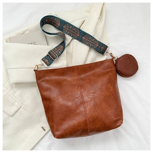 Brown vintage faux leather crossbody bag with ethnic patterned strap and mini pouch coin bag