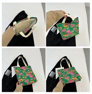 Detail of green floral canvas tote showing internal pocket and vibrant peony patterns