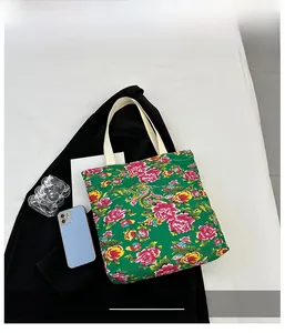 Detail of canvas tote with floral peony pattern and durable cotton ribbon handles