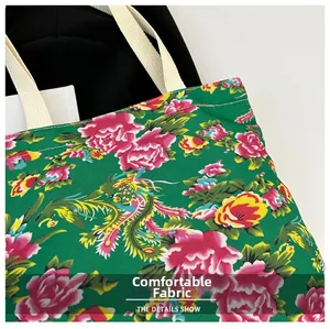 Close-up of durable canvas fabric with traditional red peony and phoenix patterns