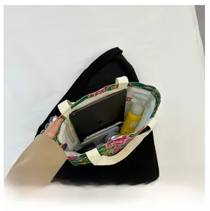 Macro view of floral canvas tote bag interior showing large capacity for daily essentials