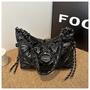 Chic black quilted puffer tote bag with glossy finish and woven rope handles for winter