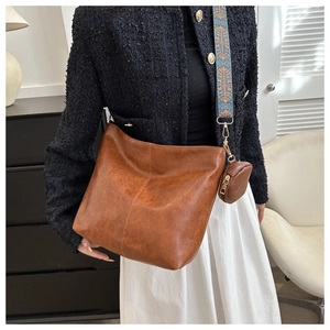 Close-up of vintage brown tote bag with colorful ethnic style wide shoulder strap