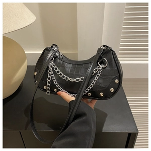 Détail du sac demi-lune en similicuir noir avec motif crocodile et chaînes argentées