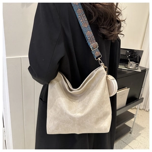 Detail of beige large capacity PU leather tote bag with ethnic jacquard wide strap