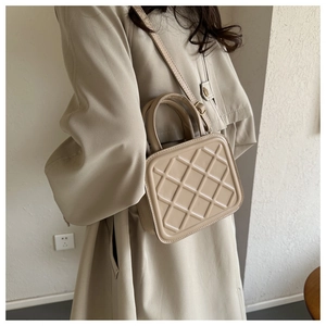 Chic beige quilted square crossbody bag with top handle and adjustable shoulder strap