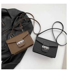 Detail view of stylish square crossbody bags with woven texture and silver metal rings