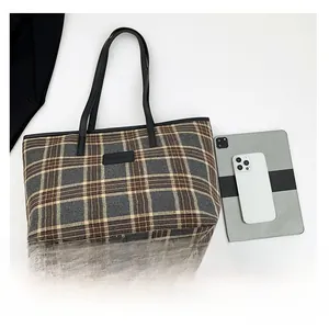 Spacious plaid tote bag detail showing capacity for tablet and phone for daily use