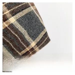 Close-up of thick checkered wool fabric texture in brown and grey tones for women bag