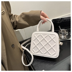 Chic quilted cream square bag with elegant handle and adjustable strap for women